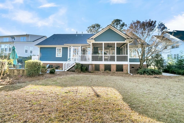 view of front of home featuring a front yard and a sunroom