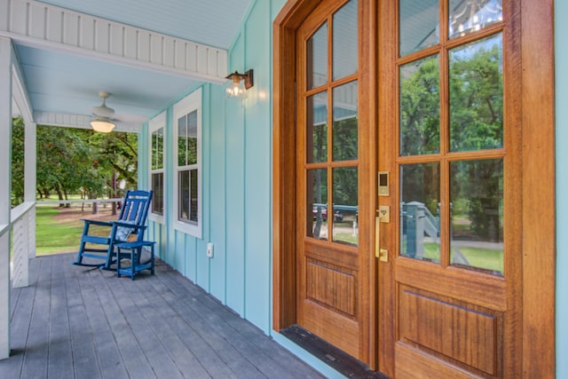 16 Oakwood Ln, Edisto Island, SC 29438 - property entrance with covered porch, ceiling fan, and board and batten siding