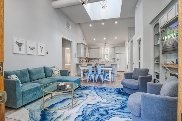 16 Oakwood Ln, Edisto Island, SC 29438 - living room featuring a skylight, light wood finished floors, high vaulted ceiling, and recessed lighting