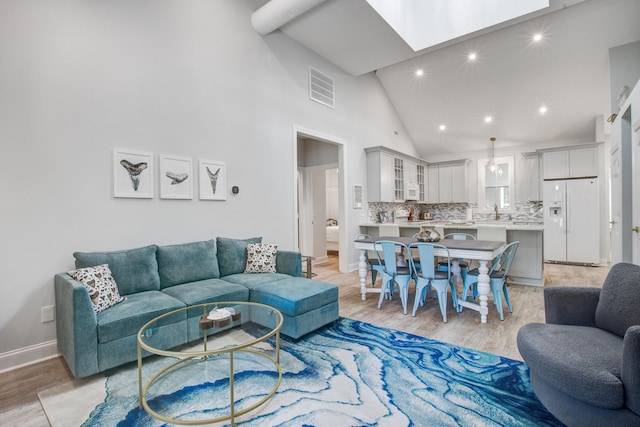16 Oakwood Ln, Edisto Island, SC 29438 - living room with light wood-style flooring, a skylight, high vaulted ceiling, and recessed lighting