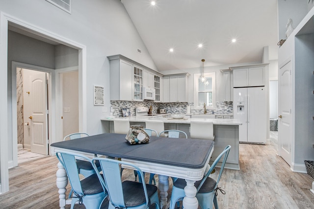 16 Oakwood Ln, Edisto Island, SC 29438 - dining space with light wood-style flooring, high vaulted ceiling, and recessed lighting