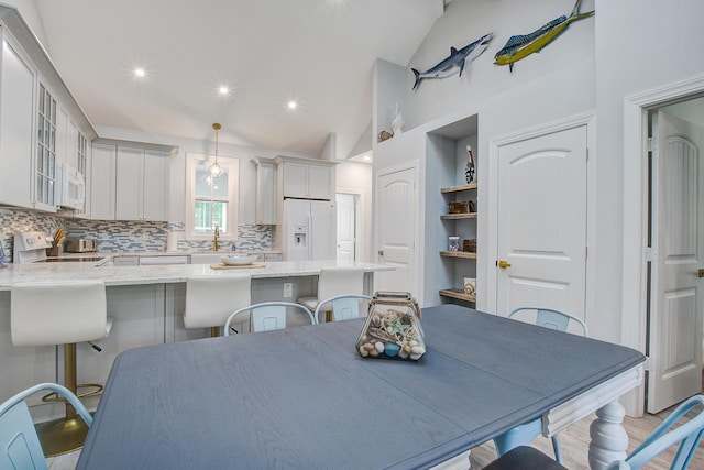 16 Oakwood Ln, Edisto Island, SC 29438 - dining area featuring high vaulted ceiling and light wood-style flooring