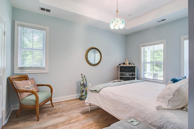 16 Oakwood Ln, Edisto Island, SC 29438 - bedroom with light wood-type flooring and a chandelier