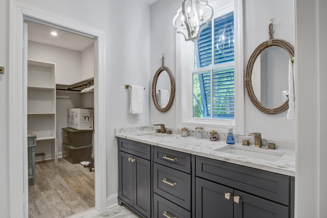 16 Oakwood Ln, Edisto Island, SC 29438 - bathroom featuring double vanity, a chandelier, a walk in closet, and wood finished floors