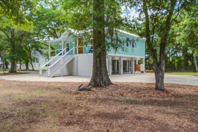 16 Oakwood Ln, Edisto Island, SC 29438 - view of front of house featuring stairs and covered porch