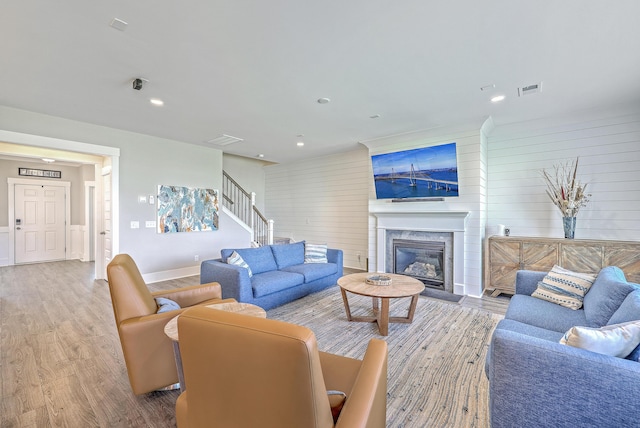 2336 Brinkley Rd, Johns Island, SC 29455 - living area with wood finished floors, wooden walls, stairway, recessed lighting, and a fireplace