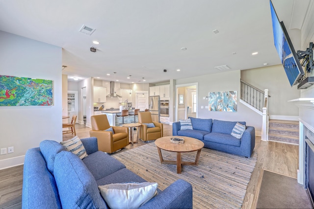 2336 Brinkley Rd, Johns Island, SC 29455 - living room featuring wood finished floors, baseboards, stairway, and recessed lighting