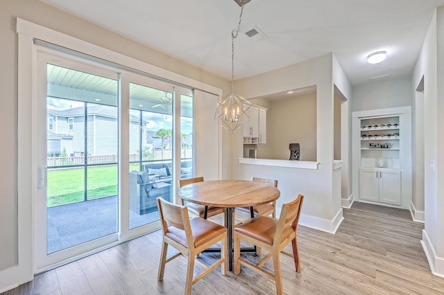 2336 Brinkley Rd, Johns Island, SC 29455 - dining area featuring light wood finished floors, a chandelier, and baseboards