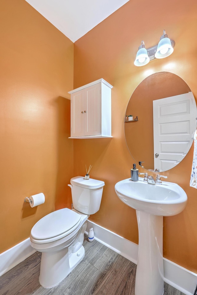 2336 Brinkley Rd, Johns Island, SC 29455 - half bathroom with baseboards, toilet, wood finished floors, and a sink