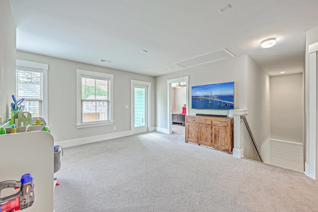 2336 Brinkley Rd, Johns Island, SC 29455 - unfurnished living room featuring attic access, carpet flooring, and baseboards