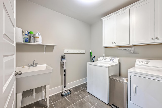 2336 Brinkley Rd, Johns Island, SC 29455 - washroom with cabinet space, washing machine and dryer, dark tile patterned floors, and baseboards