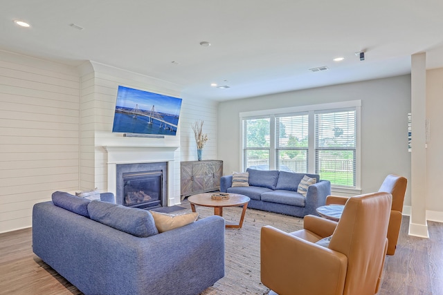 2336 Brinkley Rd, Johns Island, SC 29455 - living room featuring wood finished floors, a premium fireplace, wood walls, recessed lighting, and baseboards