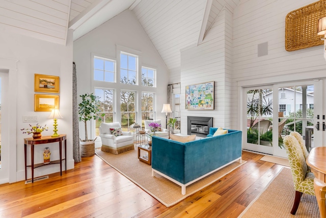 living room featuring high vaulted ceiling and hardwood / wood-style floors