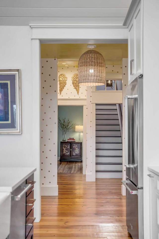 interior space featuring stainless steel fridge and light hardwood / wood-style floors