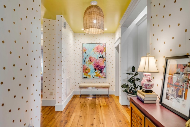 hallway featuring a notable chandelier and light wood-type flooring