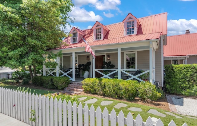 cape cod-style house featuring a porch