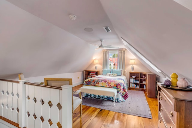 bedroom featuring lofted ceiling and light wood-type flooring