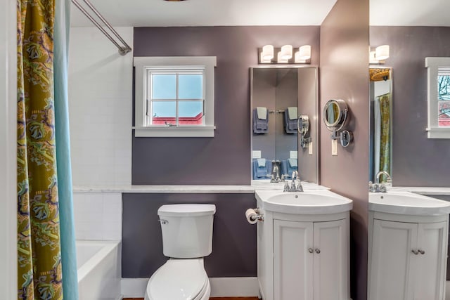 full bathroom featuring shower / bath combo, vanity, and toilet