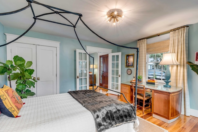 bedroom with light hardwood / wood-style floors and french doors