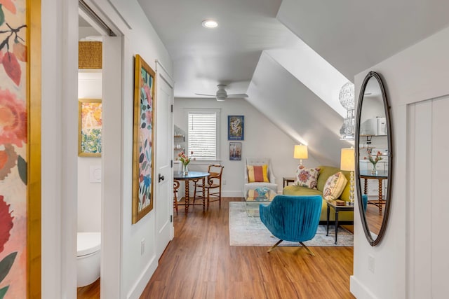 living area with hardwood / wood-style flooring and ceiling fan