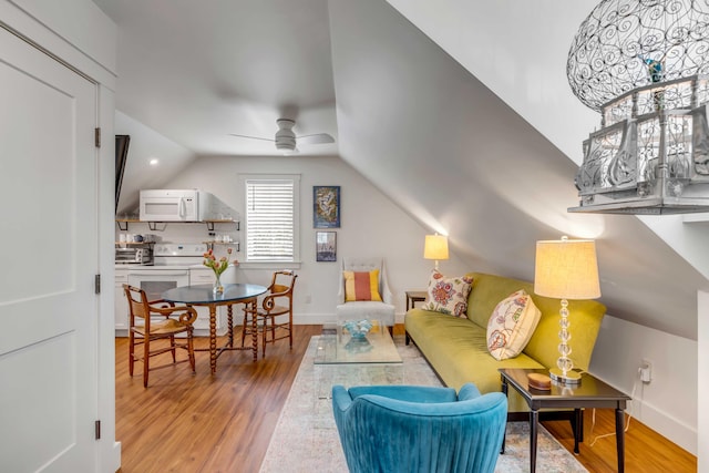 living room with hardwood / wood-style flooring, lofted ceiling, and ceiling fan