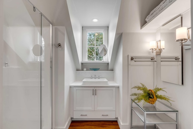 bathroom featuring a shower with door, vanity, and hardwood / wood-style floors