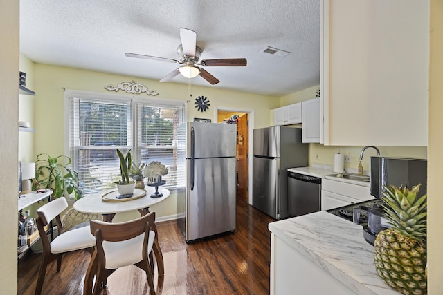 1 S Anderson Ave, Charleston, SC 29412 - kitchen with appliances with stainless steel finishes, a sink, white cabinetry, ceiling fan, and dark wood-type flooring