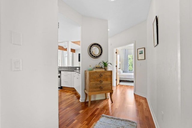 hall with light hardwood / wood-style floors and a healthy amount of sunlight