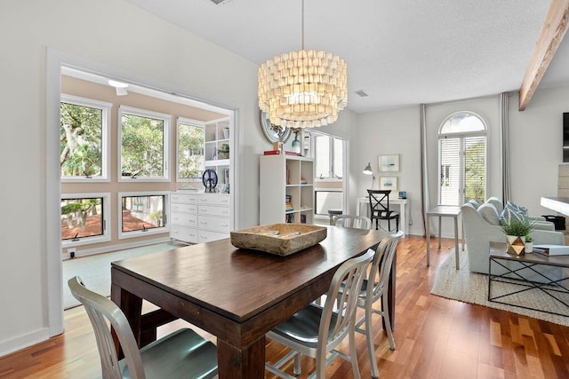 dining room with a chandelier and light wood-type flooring