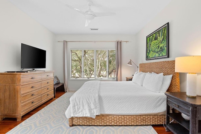 bedroom with ceiling fan and dark wood-type flooring