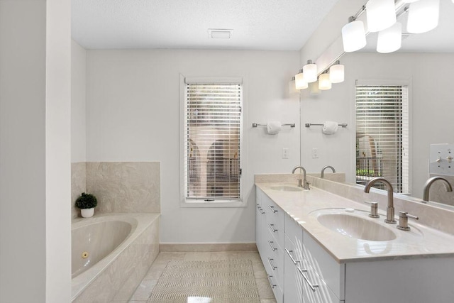 bathroom featuring vanity, a relaxing tiled tub, and tile patterned floors