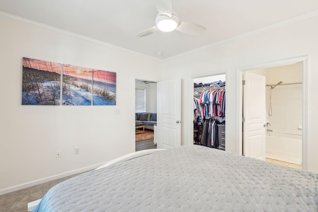 bedroom featuring ensuite bathroom, carpet floors, a closet, ceiling fan, and ornamental molding