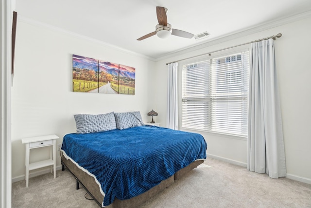 carpeted bedroom featuring crown molding and ceiling fan