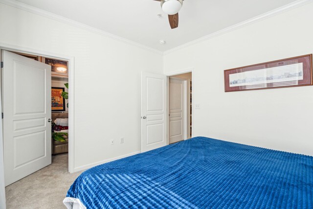 bedroom with crown molding, light colored carpet, and ceiling fan