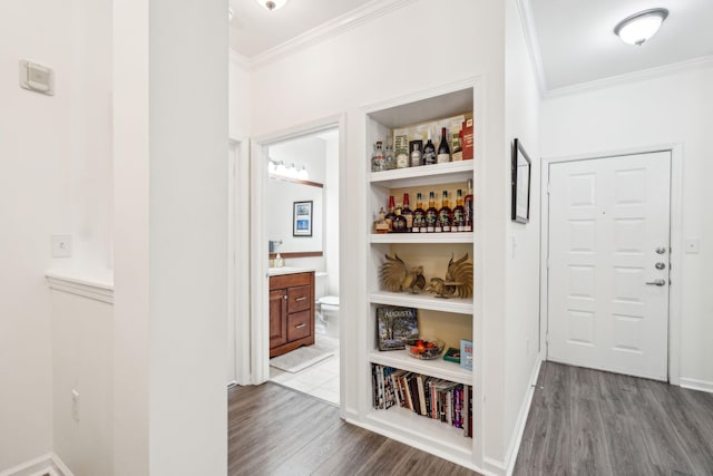 hallway with crown molding and wood-type flooring