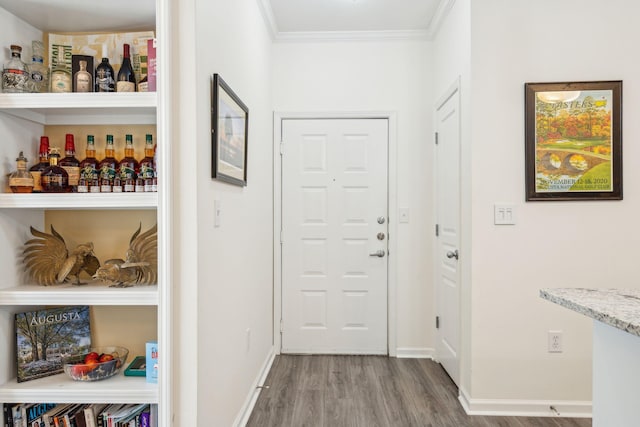 hall featuring crown molding and hardwood / wood-style flooring