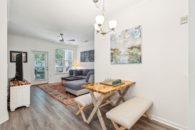 dining room featuring crown molding, hardwood / wood-style flooring, and ceiling fan with notable chandelier