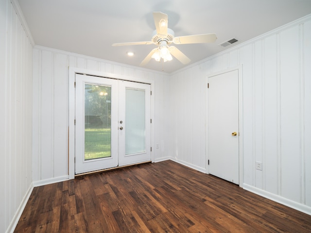 empty room with crown molding, dark hardwood / wood-style flooring, ceiling fan, and french doors