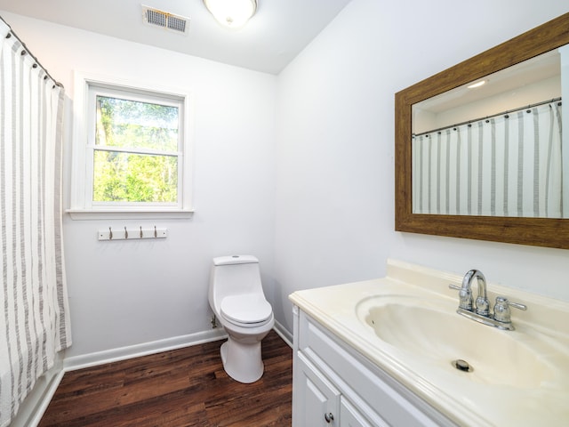 bathroom featuring vanity, hardwood / wood-style floors, and toilet