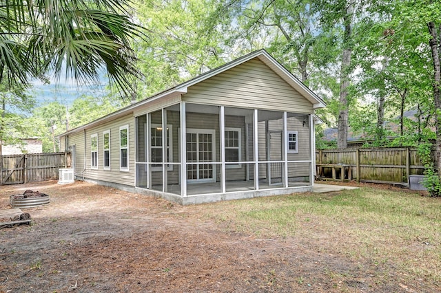 1453 Joy Ave, Charleston, SC 29407 - back of property with a fire pit, a sunroom, a fenced backyard, and central AC unit