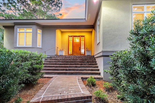 view of exterior entry at dusk