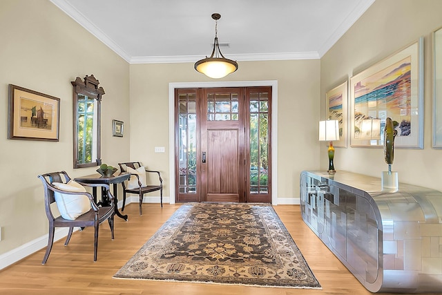 foyer entrance featuring crown molding and light hardwood / wood-style flooring