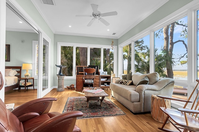 sunroom / solarium featuring ceiling fan