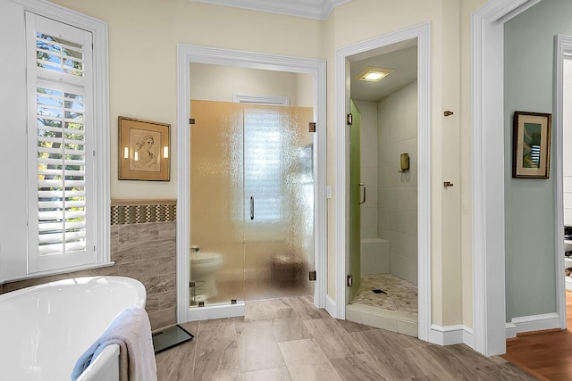 bathroom featuring separate shower and tub and tile walls