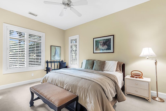 bedroom with light carpet and ceiling fan