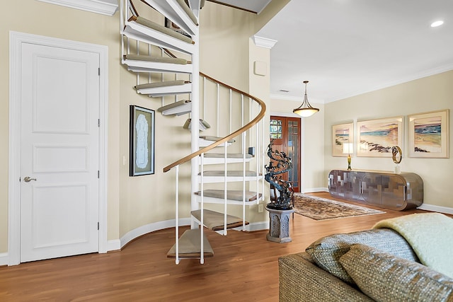 stairway featuring ornamental molding and wood-type flooring