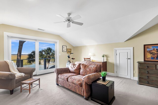 carpeted living room featuring ceiling fan and vaulted ceiling