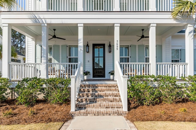 view of exterior entry with covered porch and a ceiling fan