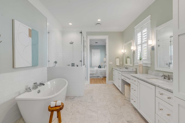 ensuite bathroom with a stall shower, a soaking tub, ensuite bathroom, marble finish floor, and vanity