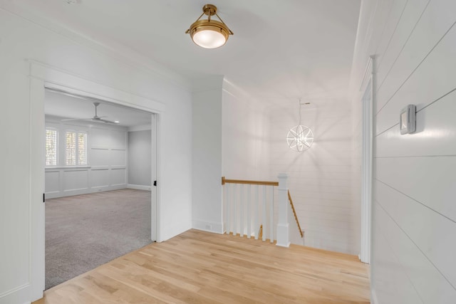 carpeted spare room with wood finished floors